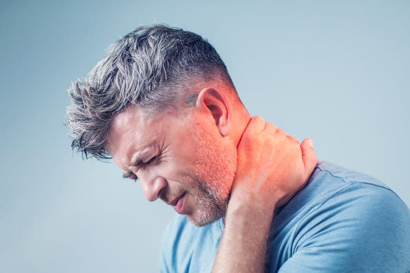 A person holding a painful neck